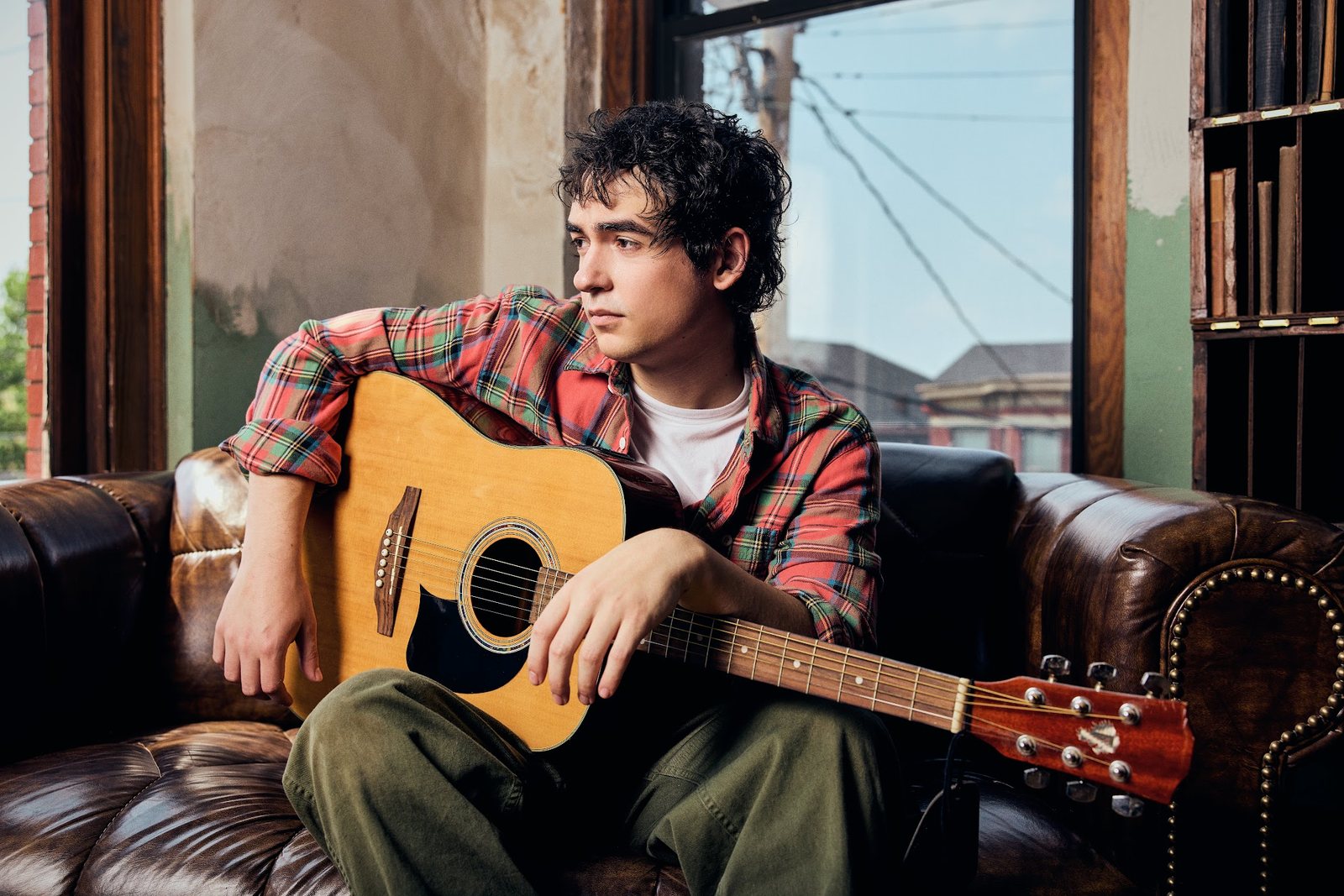 Alex Angelo with his guitar in Nashville